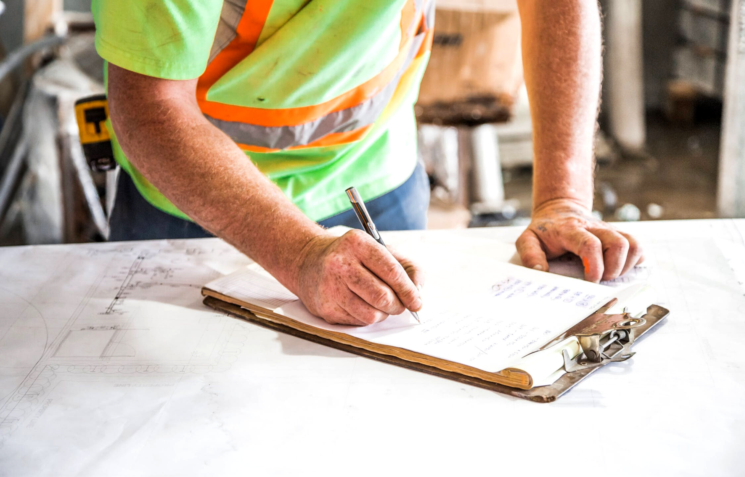 Man writing on a clipboard